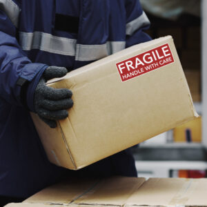 Picking up package fragile boxes in loading area of cold storage warehouse prepare to transfer storage in the freezing room, Warehouse Storage System Support Logistics Business in Banner size.