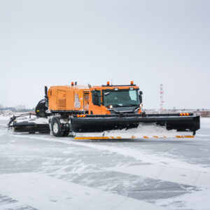 Airfield sweeper-vacuum machine and snow blower universal cleaning truck on the winter runway
